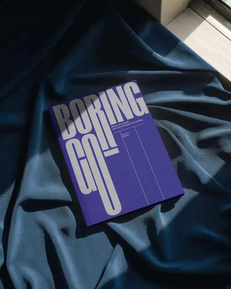 Hardcover Magazine Mockup Lying On Textured Fabric With Natural Light Shadow Play