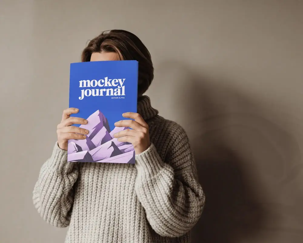 Person Holding Blank Magazine Mockup Cover To Showcase Customized Print Design