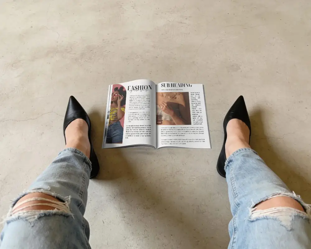 Stylish Open Magazine Mockup Placed On Minimalist Concrete Floor With Casual Worn Denim Jeans