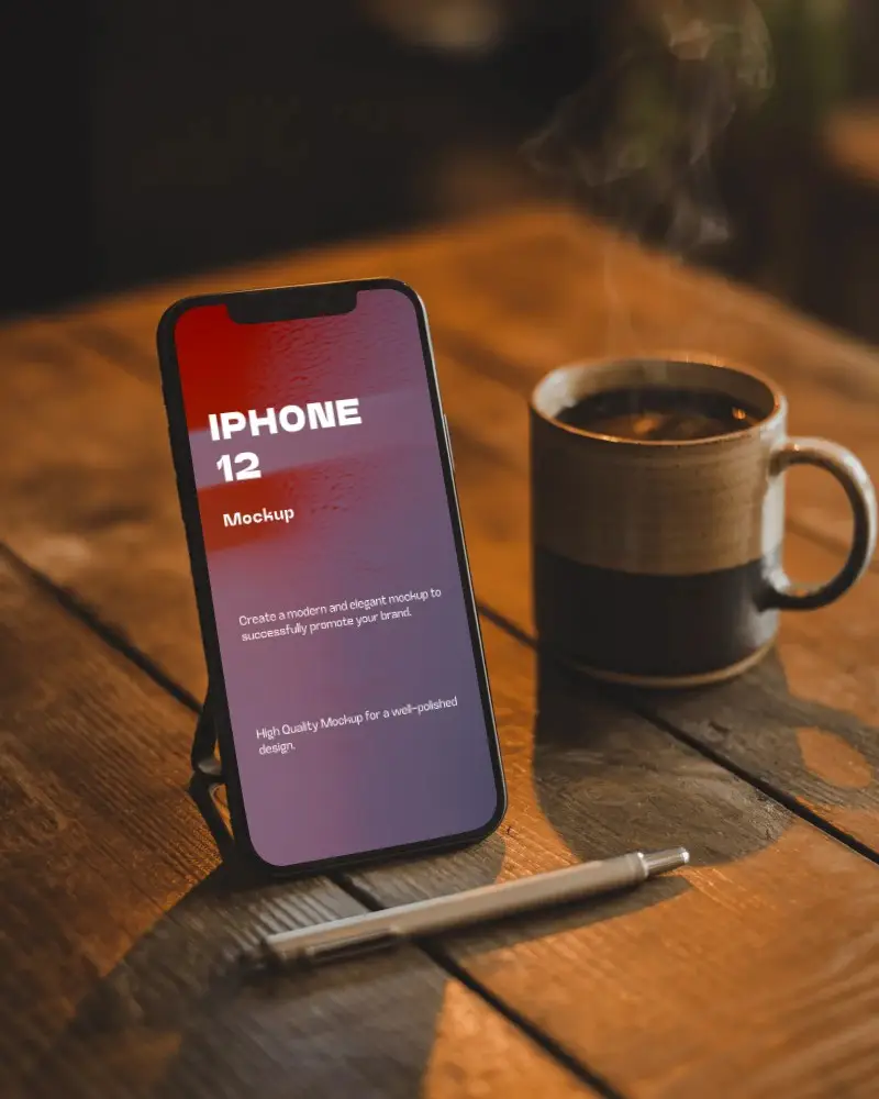 Iphone 12 Mockup On Rustic Wooden Table With Steaming Coffee Mug And Pen In Cozy Light