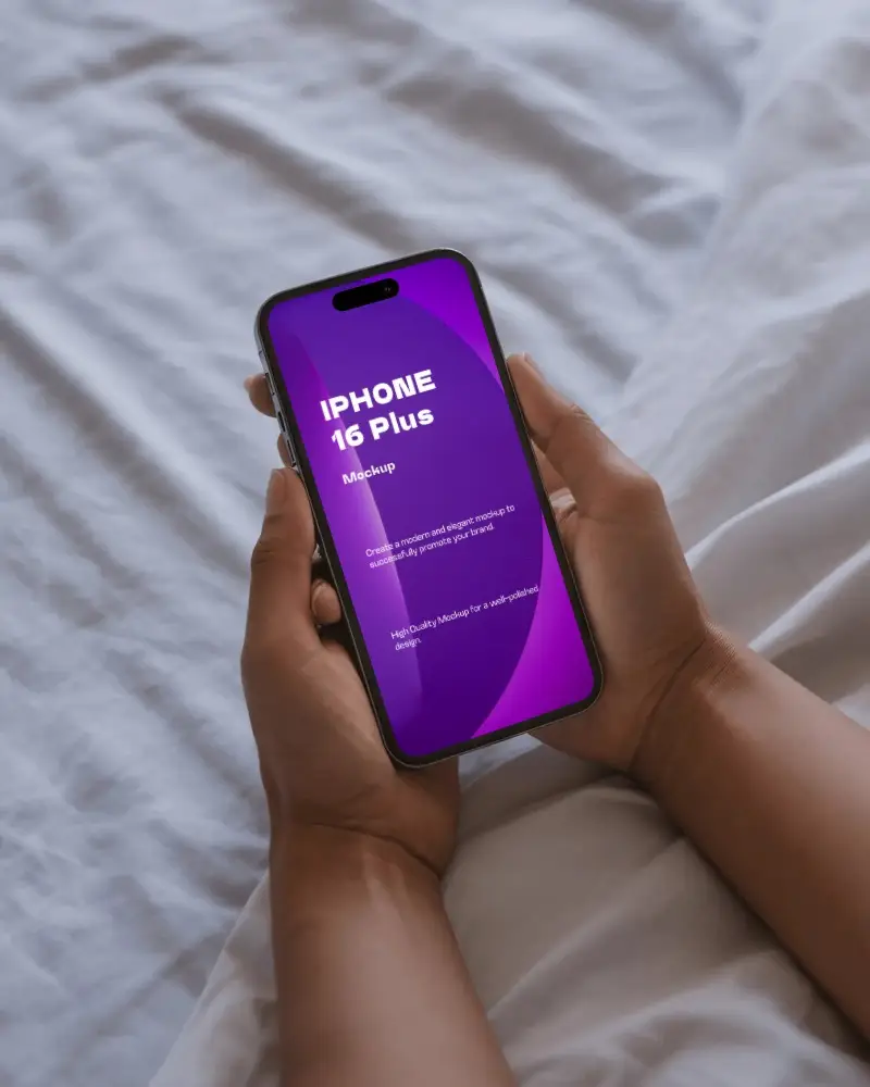 Iphone 16 Plus Mockup Handheld Over White Bedsheet In Cozy Morning Light Bedroom Scene