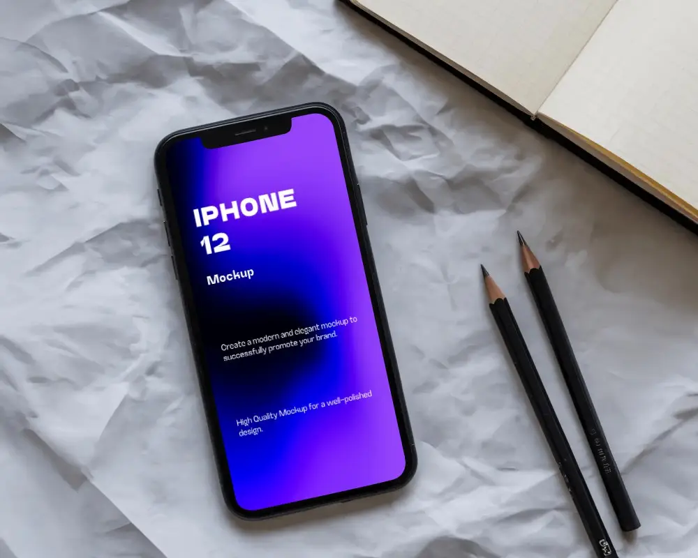 Aesthetic Desk Scene Iphone 12 Mockup On Wrinkled Sheet With Open Notebook And Pencil Pair