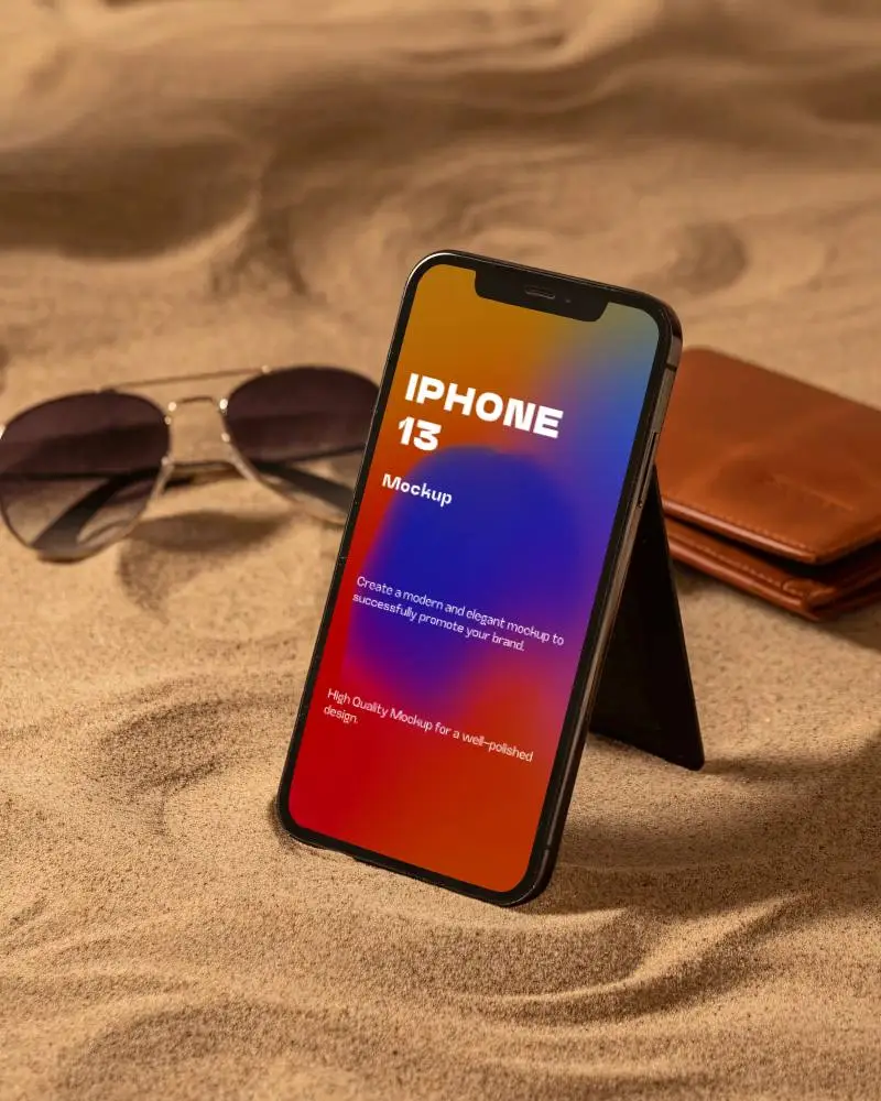 Desert Style Iphone 13 Mockup On Sand With Sunglasses And Leather Wallet In Warm Light