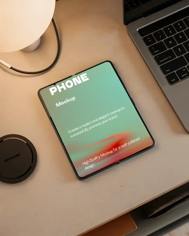 Samsung Modern Foldable Phone Mockup On Clean Desk Next To Laptop And Wireless Charging Pad