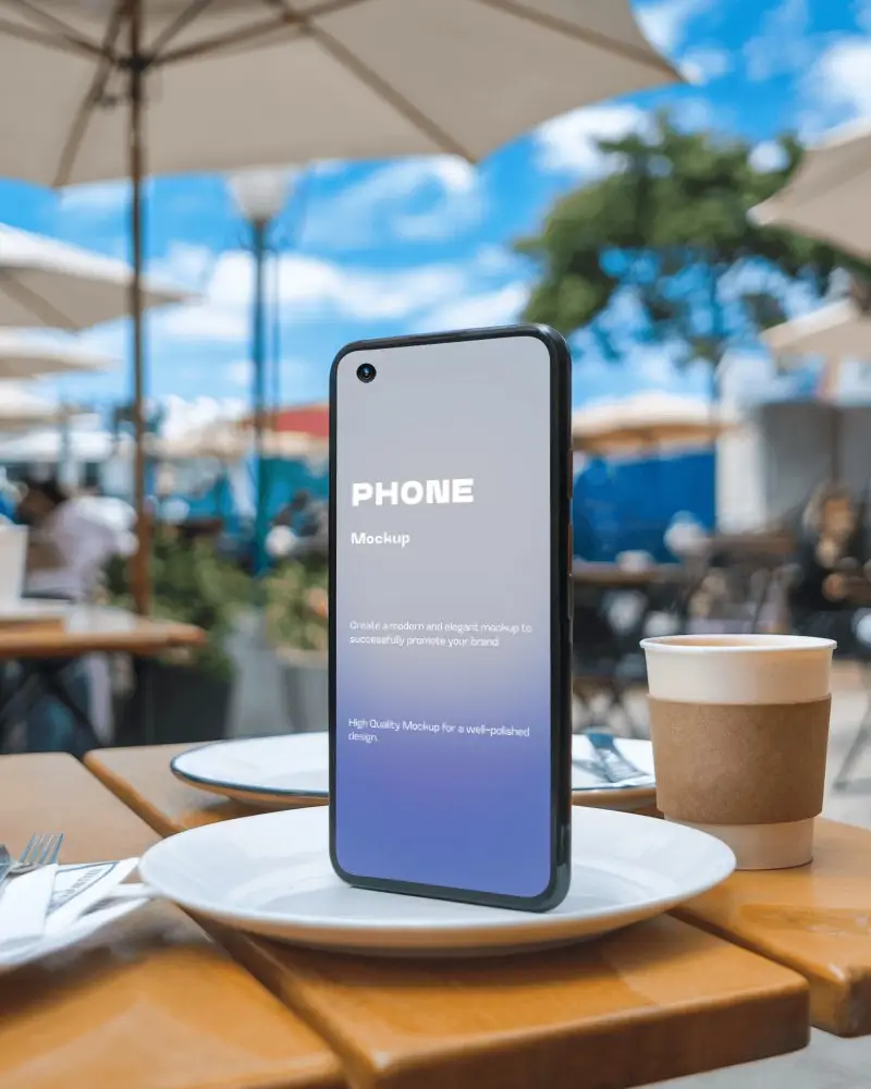 Outdoor Cafe Smartphone Mockup On Table With Coffee Cup And Blue Sky Background