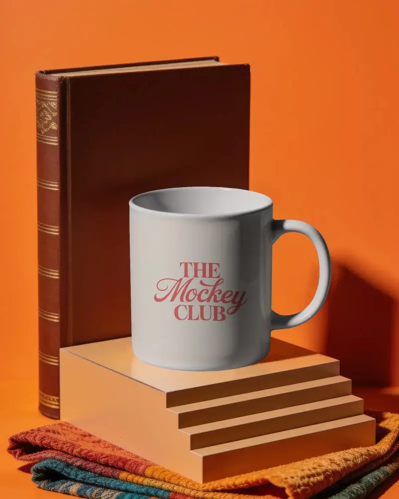 Sleek Stylish Coffee Mug Mockup With Step Podium And Textured Cloth Setting For Brand Presentations