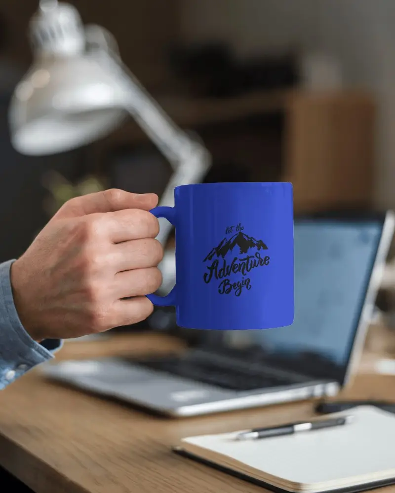 Workspace Mug Mockup White Coffee Cup With Design Space Held By Hand On Desk With Laptop And Notebook Focus On Productivity And Professional Setting