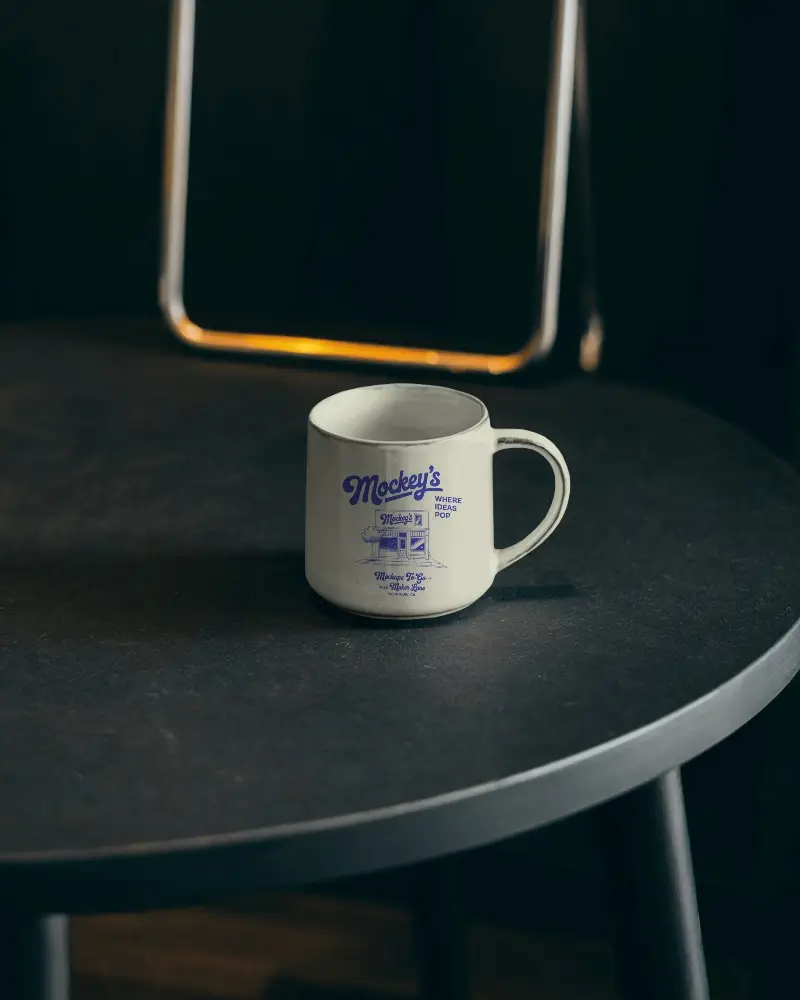 Simple Elegant Dining Room Ceramic Mug Mockup On Smooth Textured Round Table