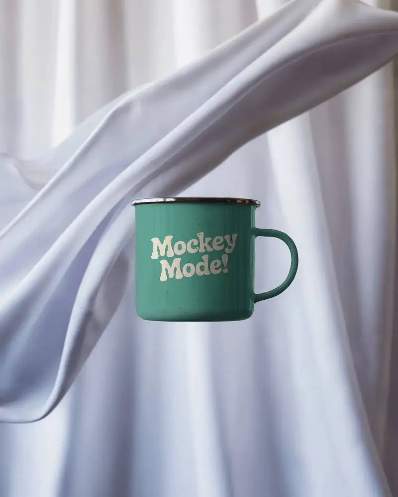 Vintage Metal Enamel Mug Mockup With Circular Handle Floating Against Soft Fabric Background