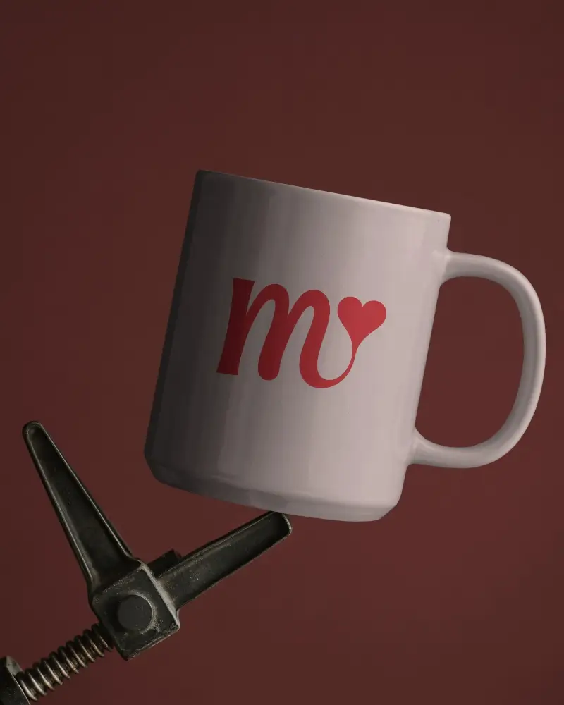 Sleek Ceramic Mug Mockup Gripped By Industrial Clamp On Deep Red Backdrop Clean Visual