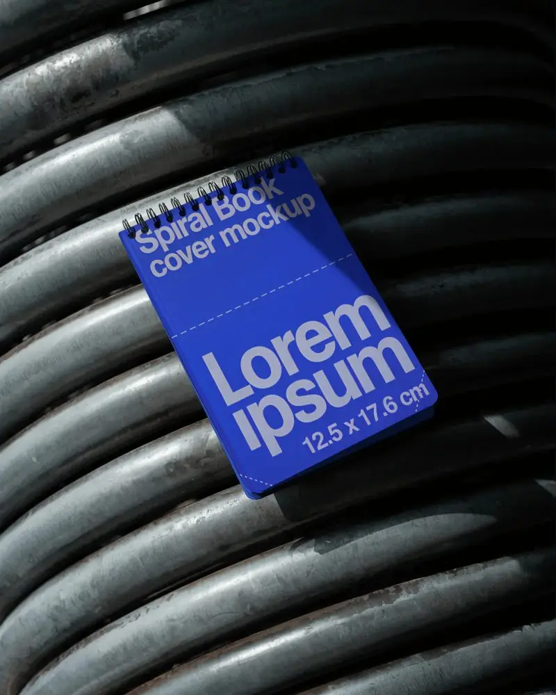 Spiral Bound Notebook Mockup Placed On Curved Metal Pipes For Modern Creative Design