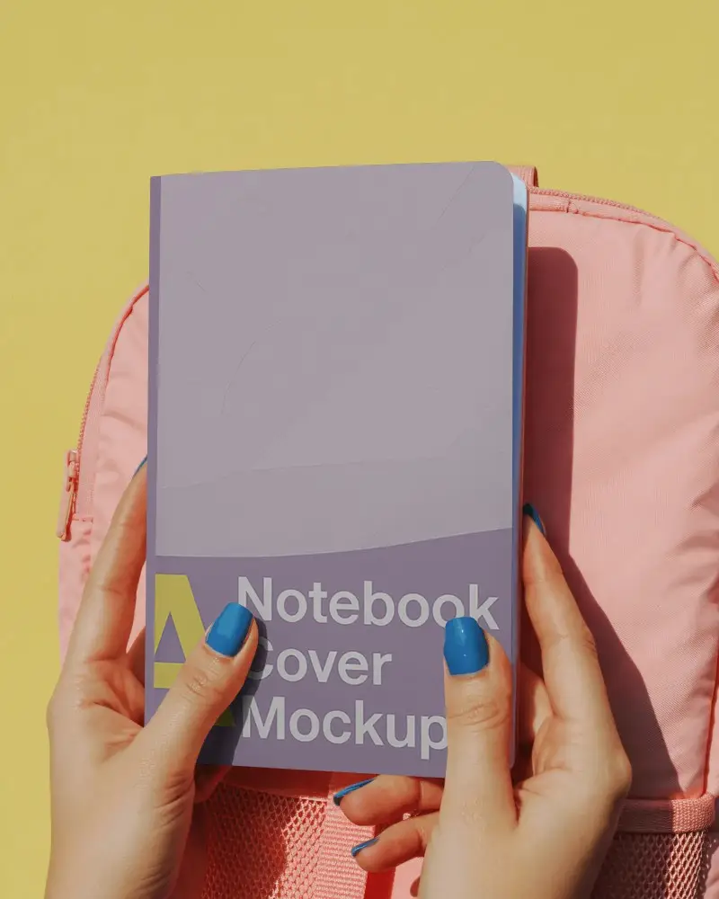 Bright Back To School Notebook Mockup Held In Hands With Pink Backpack On Yellow Background
