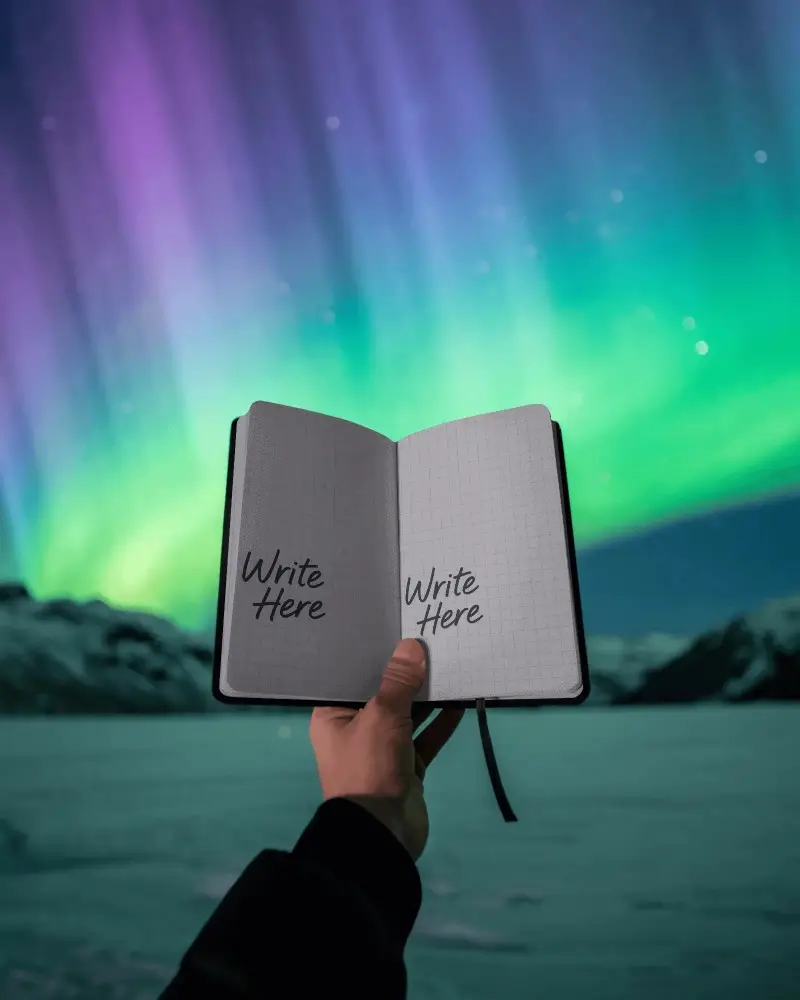 Aurora Borealis Open Notebook Mockup With Handheld View And Glowing Night Sky