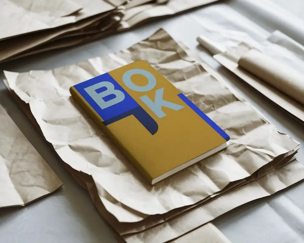 Sleek Notebook Mockup Angled View On Wrinkled Paper Sheet Creative Stationery Layout