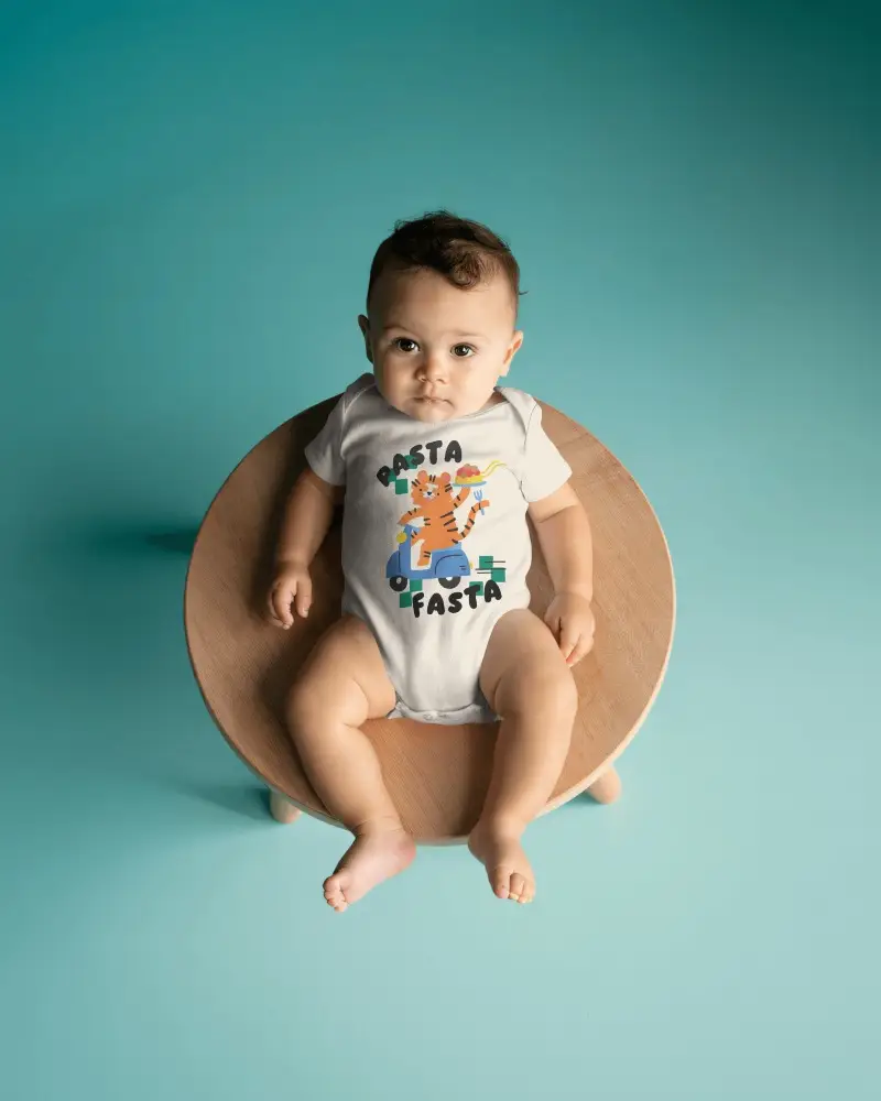 Studio Baby Onesie Mockup Infant Seated On Round Wooden Chair Clean Teal Backdrop