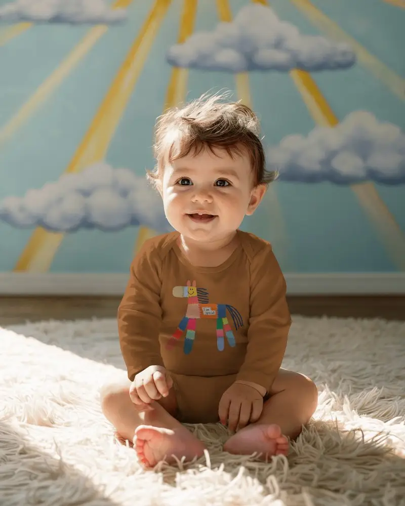 Sunny Nursery Baby Onesie Mockup Sitting Smiling Infant Cloud Wall Art Warm Natural Light