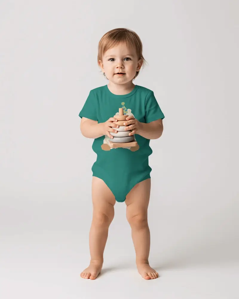 Studio Baby Onesie Mockup Standing Toddler Holding Toy Front View Clean White Background