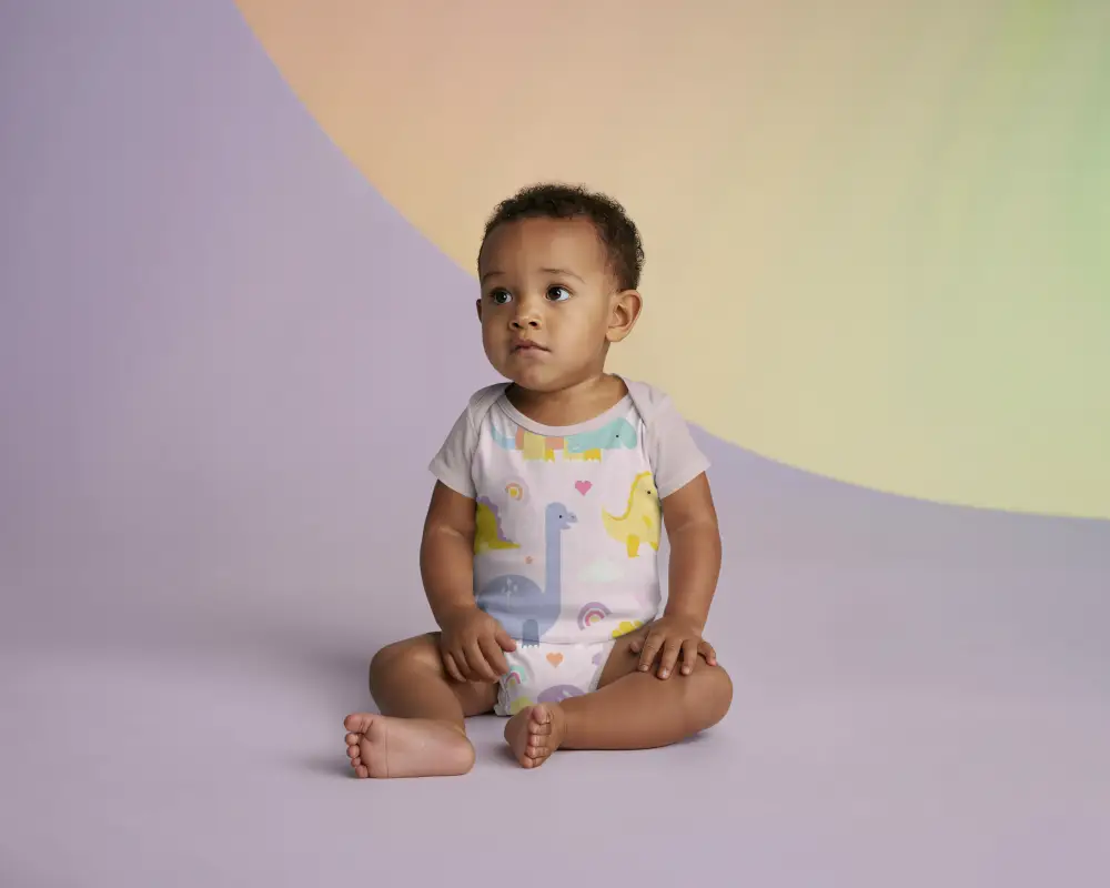 Baby Onesie Mockup Infant Sitting On Colorful Studio Background For Kidswear Design