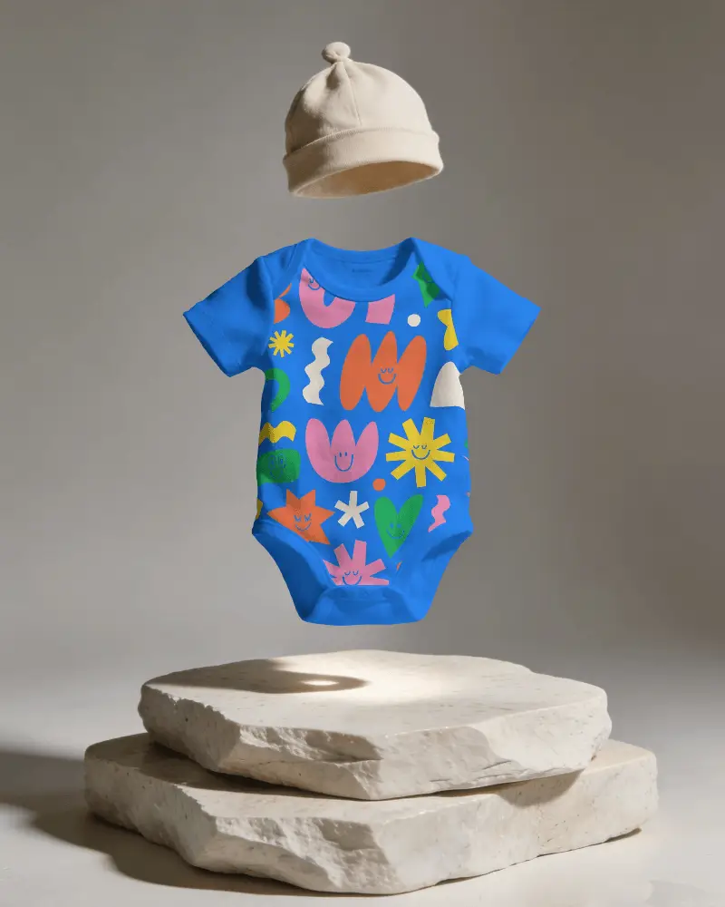 Infant Onese Mockup With Short Sleeves And Knot Beanie Floating Over Rough Stone Surface Display