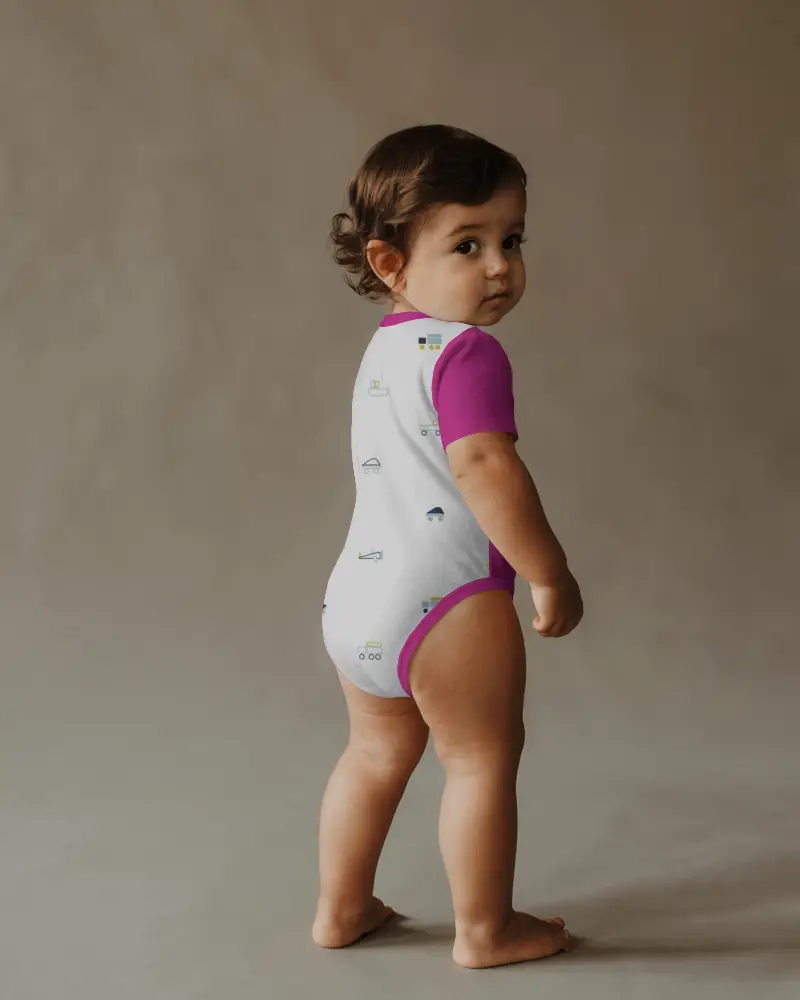 Cinematic Back Angle Onesie Mockup Toddler Turning Head In Soft Textured Studio Space