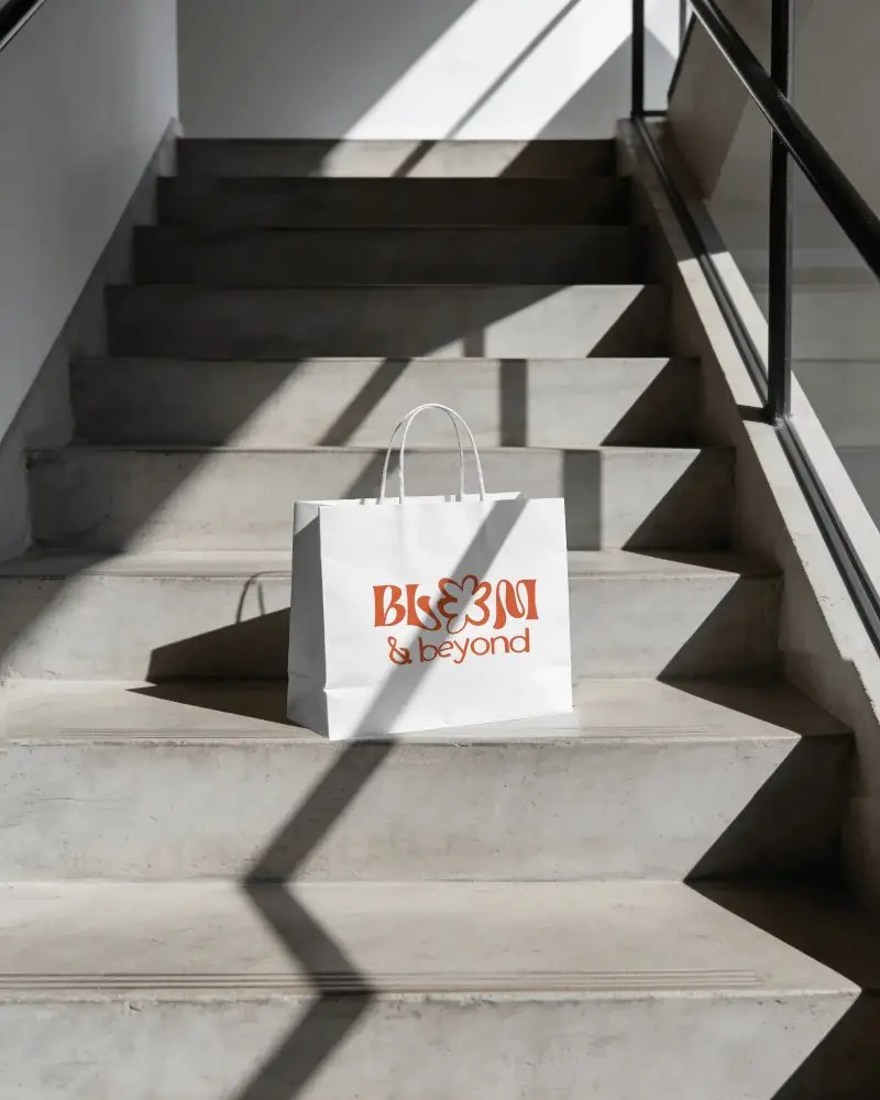Eco Friendly Paper Bag Mockup On Staircase Ideal For Retail Packaging Branding Presentation