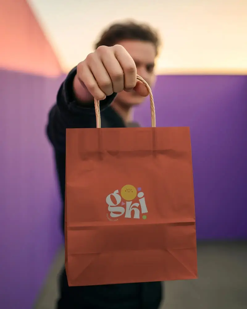 Eco Friendly Paper Bag Mockup With Twisted Rope Handle Held By Hand For Brand Promotion