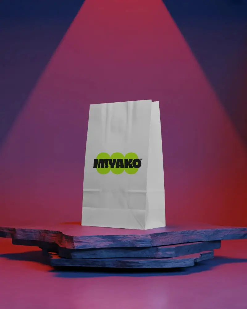 Eco Friendly Paper Bag Mockup Display On Textured Platform With Colorful Stage Lighting