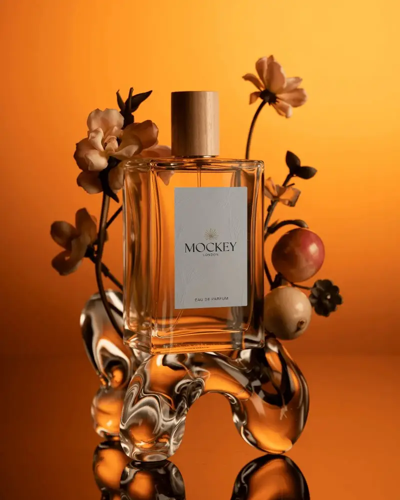 Luxury Perfume Bottle Mockup With Floral And Fruit Accents On Abstract Glass Stand