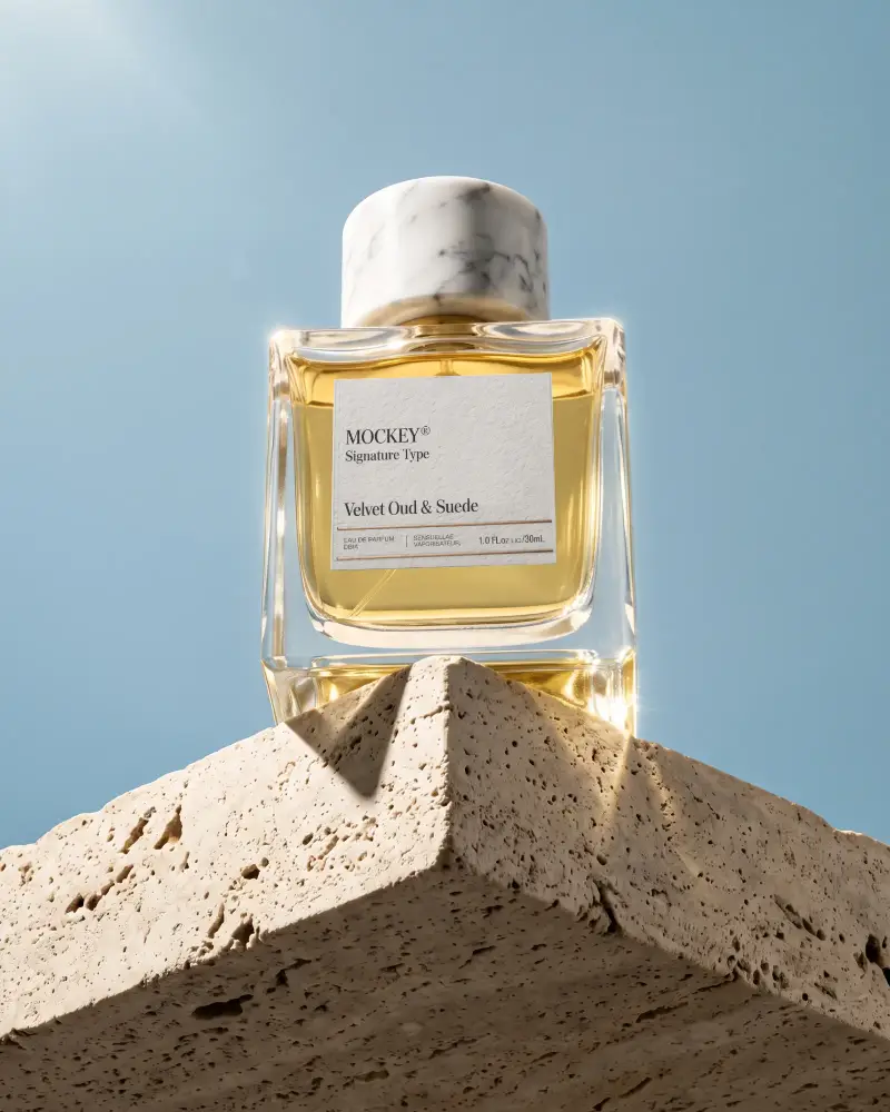 Luxury Perfume Bottle Mockup With Marble Cap And Textured Label Display On Natural Stone