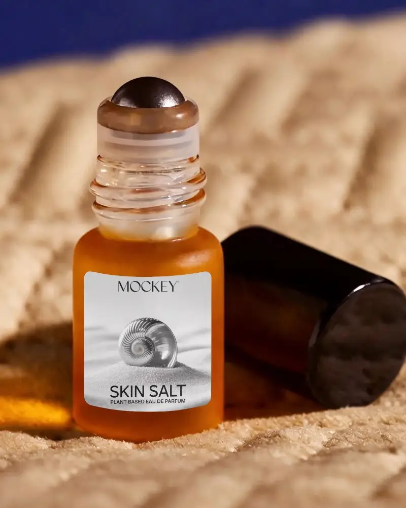 Elegant Glass Rollerball Perfume Mockup On Textured Surface Background