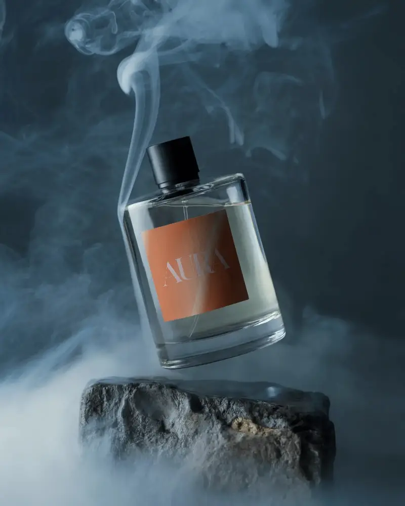 Elegant Glass Perfume Mockup Hovering Above Stone In Enigmatic Smoke Background