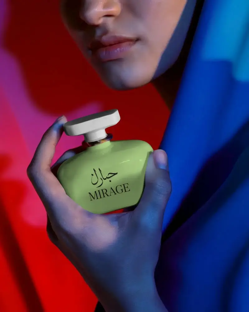 Luxury Elegant Perfume Bottle Mockup Held By Feminine Hand Against Vibrant Background