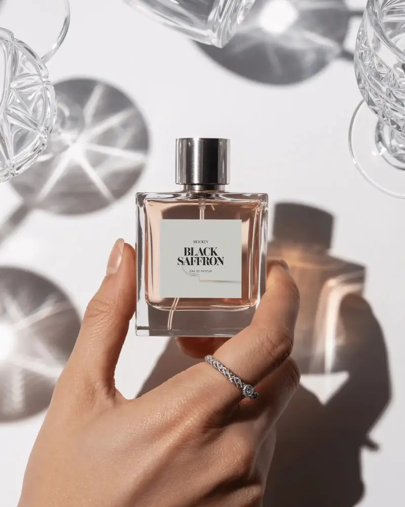 Premium Perfume Bottle Mockup Hand Displaying Square Glass Surrounded By Sunlit Crystal Shadows