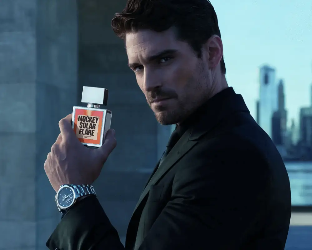 Confident Male Model Holding Luxury Perfume Bottle In Cityscape Background Stylish Modern Look
