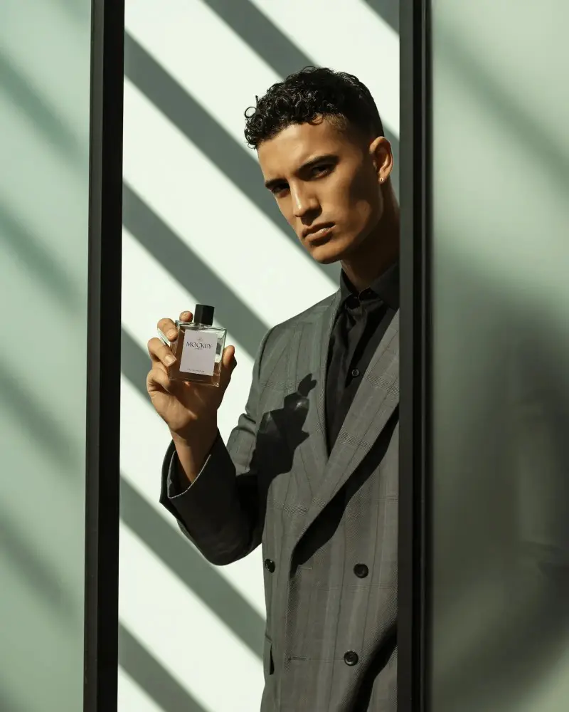 Luxury Men Fragrance Mockup Elegant Male Model Holding Bottle In Shadow Lines
