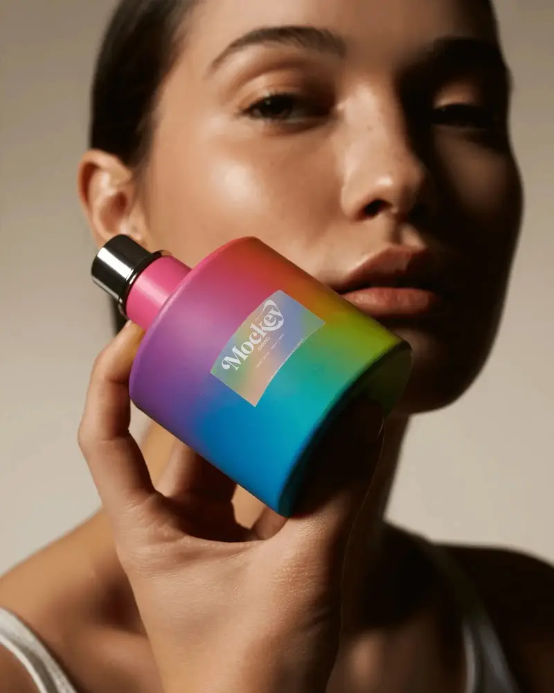 Vibrant Rainbow Perfume Mockup Held Close To Face With Soft Warm Studio Lighting