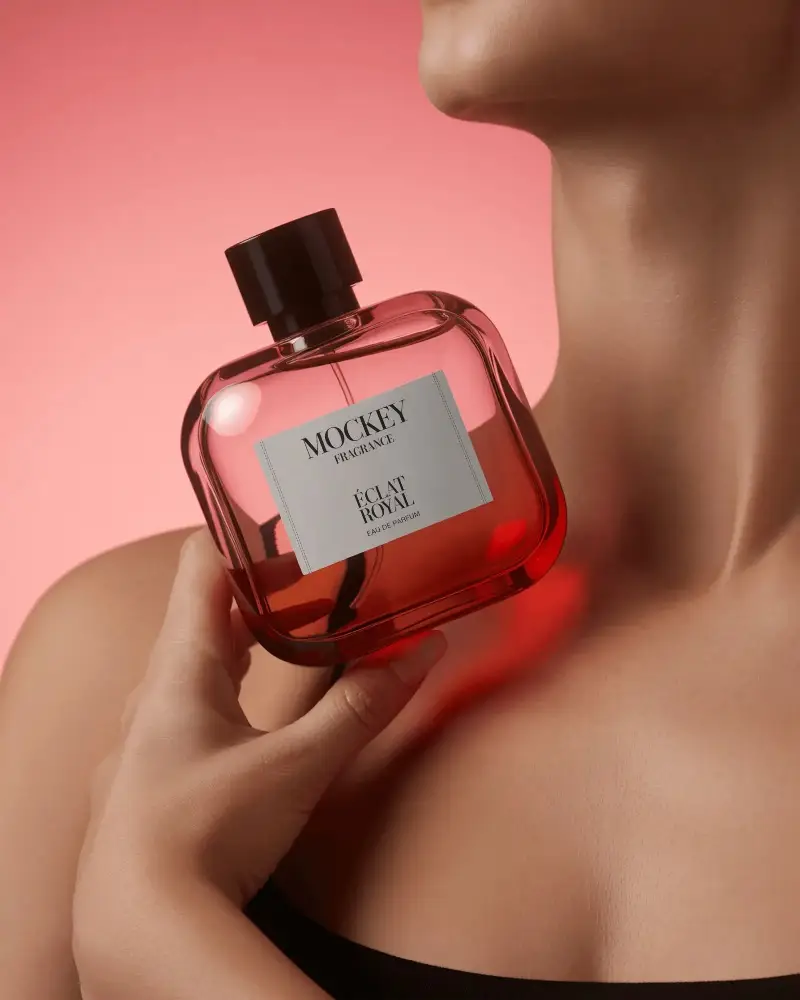 Sleek Red Perfume Mockup Held Near Neck With Soft Pink Gradient Lighting