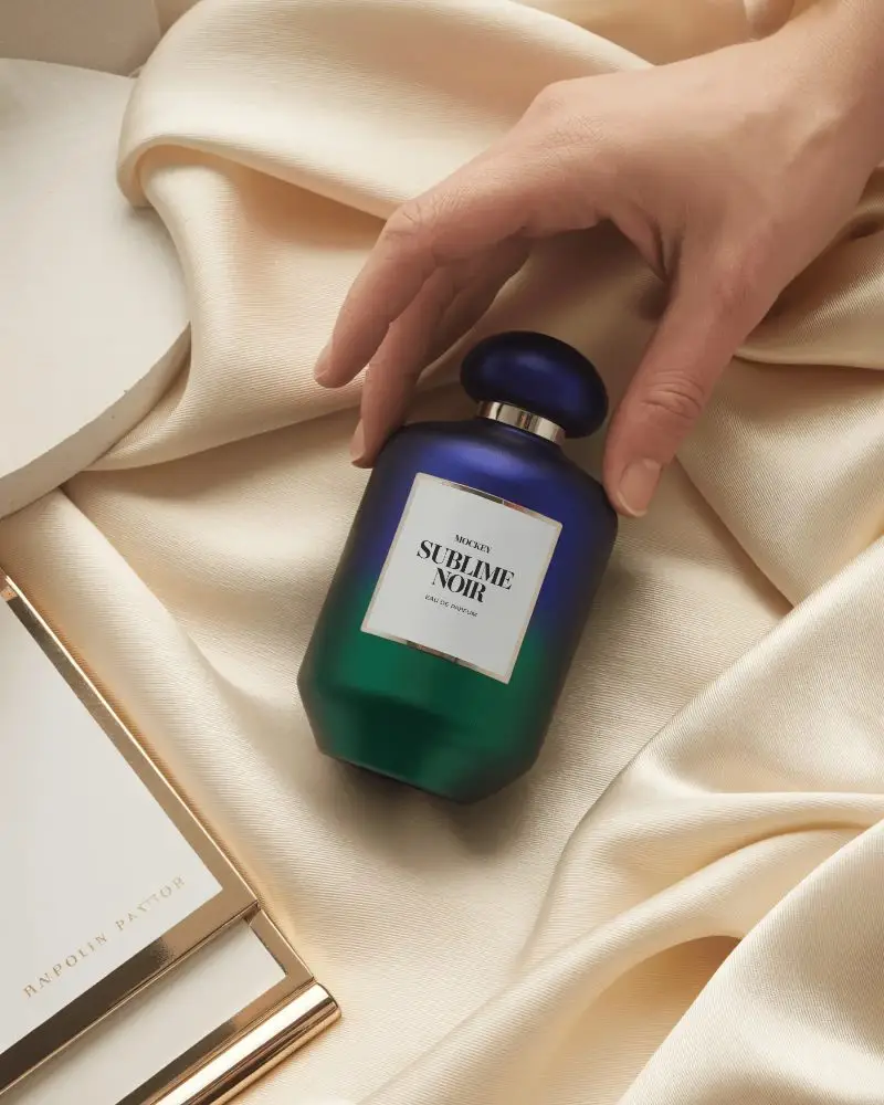 Elegant Duotone Perfume Mockup Held On Soft Ivory Fabric With Luxury Styling Accents
