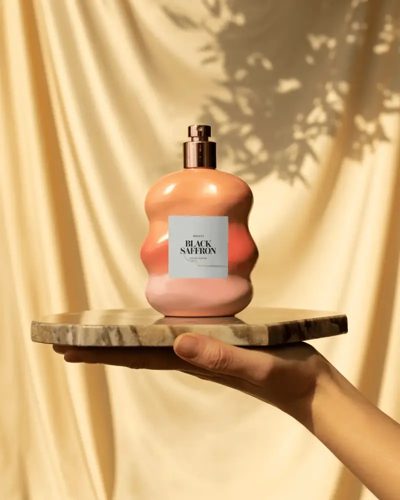 Sculpted Peach Perfume Mockup On Marble Platform In Warm Sunlit Drape Setting