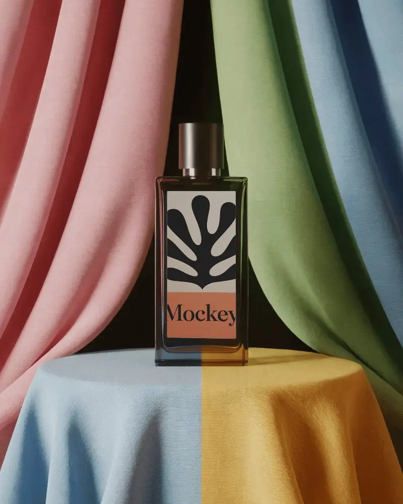 Artistic Perfume Mockup Glass Bottle On Draped Fabric Pedestal Color Block Studio Scene