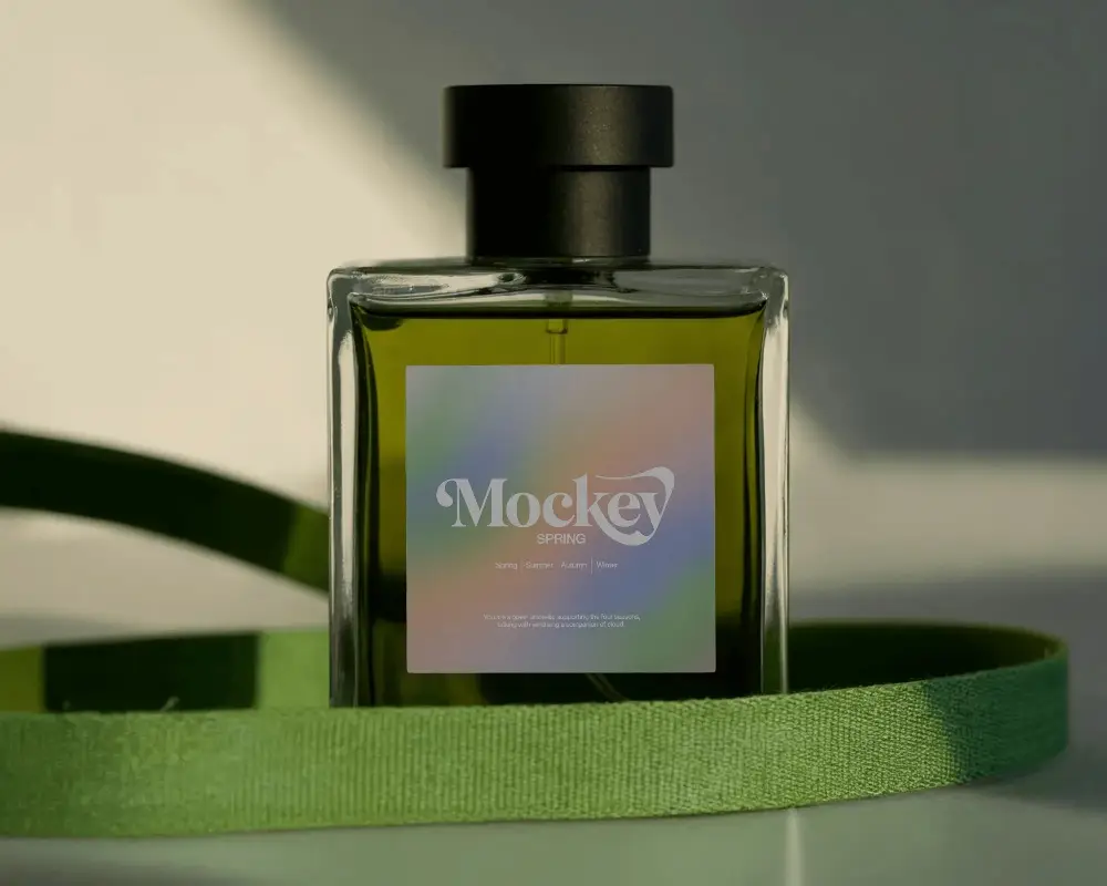 Green Perfume Mockup Square Glass Bottle With Fabric Ribbon Natural Light Studio Scene