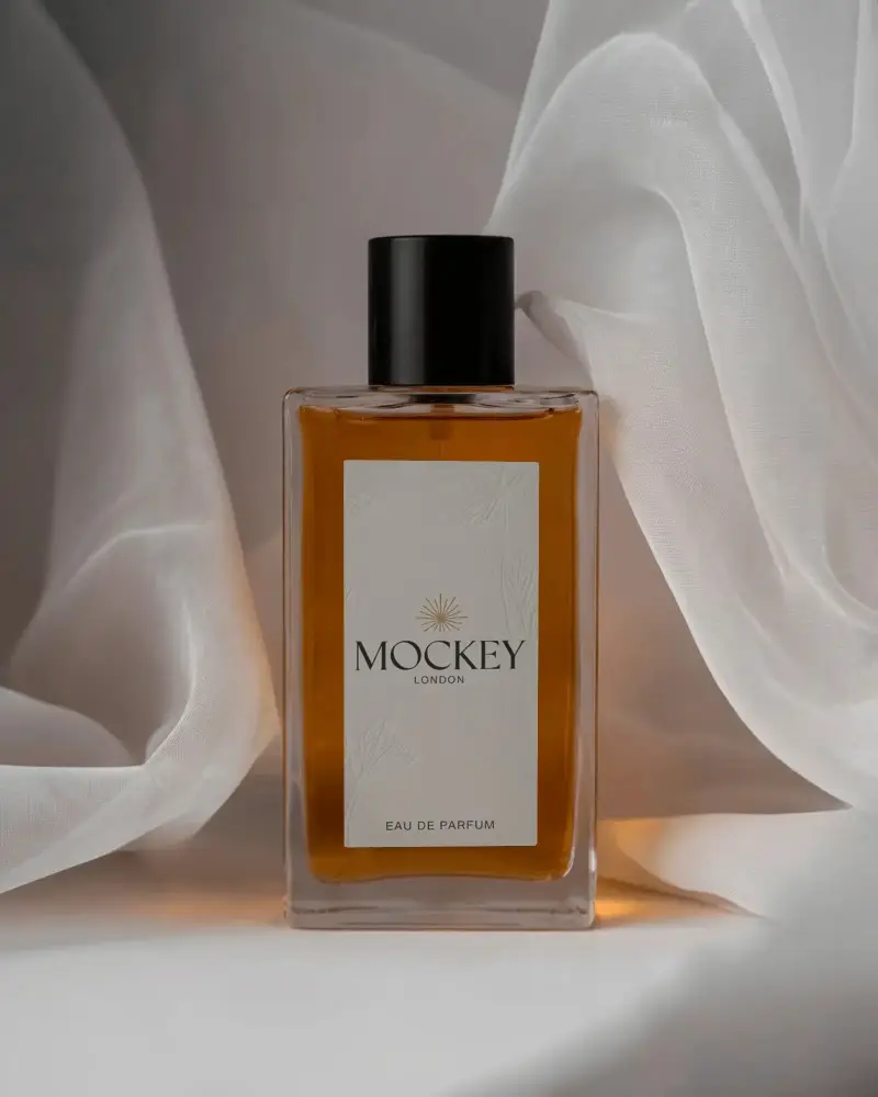 Luxury Perfume Mockup Amber Glass Bottle Framed By Sheer White Fabric Soft Studio Light