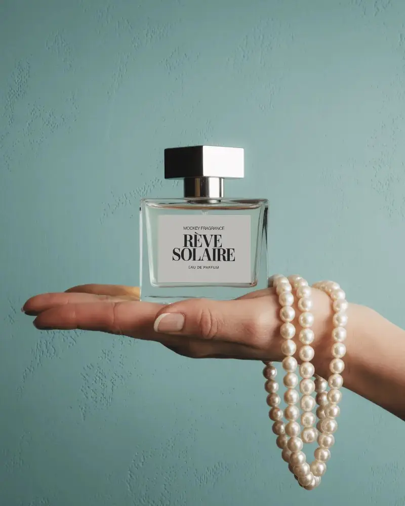 luxury-perfume-bottle-mockup-on-hand-with-pearl-necklace-against-pastel-background-elegant-style