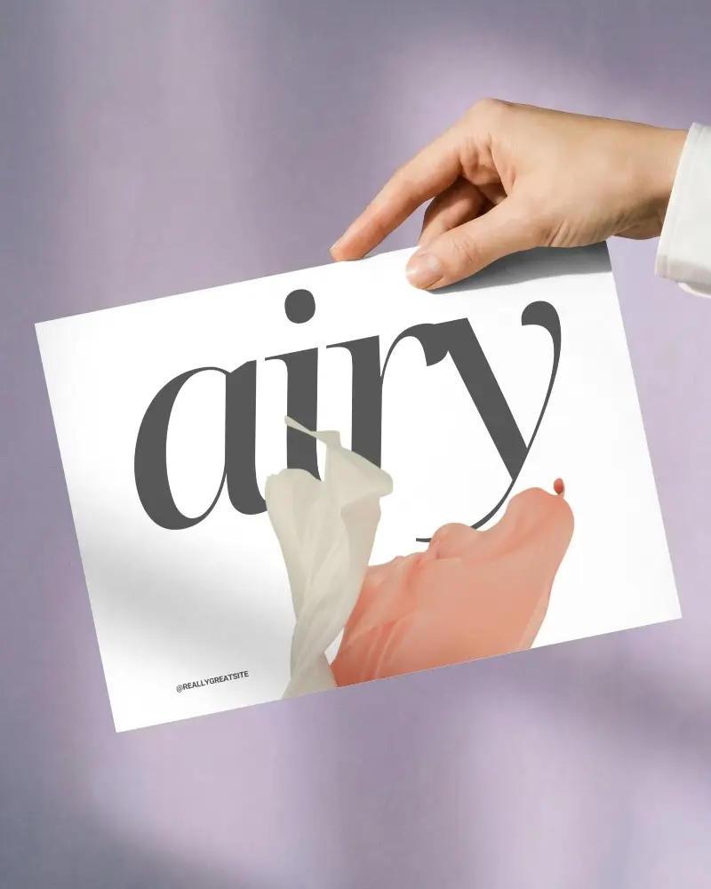 Hand Holding Blank Paper Poster Mockup Against Soft Gradient Background For Design