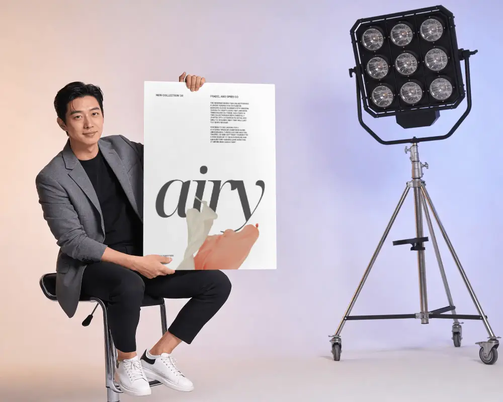 Professional Male Model Holding Poster Mockup In Modern Studio Setting For Advertising