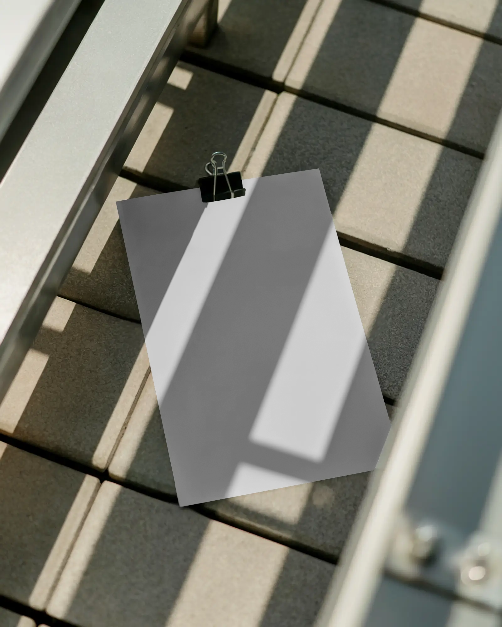 Realistic Poster Mockup With Metal Clip On Tiled Surface Showcasing Shadow Play Effects