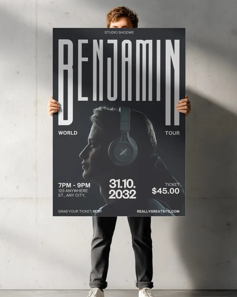 Vertical Poster Mockup Held By Model Against Minimalist Concrete Wall With Light Shadows
