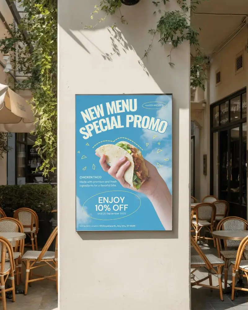 Street Wall Mounted Poster Mockup Surrounded By Cafe Chairs And Tables