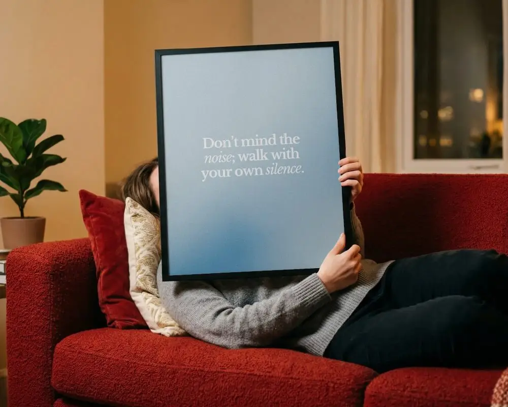 Cozy Relaxing Interior With Person Holding Poster Mockup On Soft Textured Couch Background