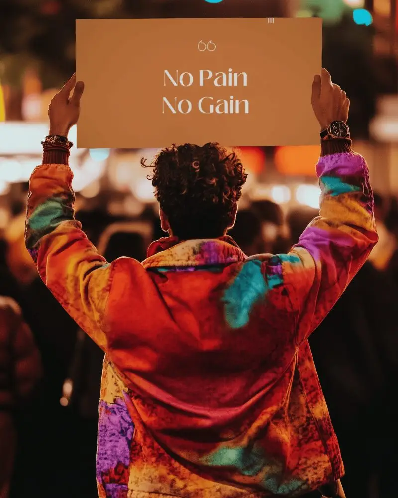 Nighttime Scene Poster Mockup Held By Person In Colorful Jacket With Crowd Background Urban Vibe Presentation